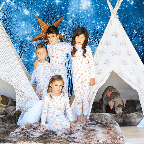 four children wearing gingerbread men holiday print pajamas Petidoux 